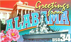 Alabama Greeting: In the background is the state capitol in Montgomery; in the foreground, the battleship USS Alabama in port at Mobile. The camellia, the state flower, is at the lower left. The state travel authority advised against using the color combinations blue and gold or red and white in the letters of the state's name, as they are the colors of arch-rival Auburn and University of Alabama sports teams, respectively. Busch rendered the letters in neutral shades of green, blue and white.