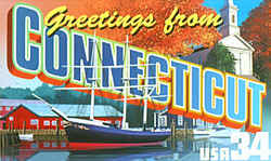 Connecticut Greeting: A harbor scene in Mystic Seaport, with a moored sailing ship, docks and buildings, occupies the foreground. At the rear is a white Connecticut church, not further identified, surrounded by autumn foliage.