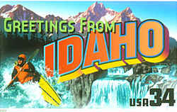 Idaho Greeting: A thrill-seeker in a yellow kayak plunges through white water on the left. A view of Shoshone Falls on the Snake River is at the right, while the Sawtooth Range of mountains is seen against the sky at the rear.