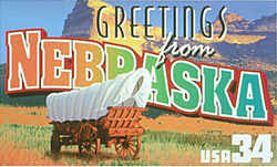 Nebraska Greeting: The design recalls the days in the mid-19th century when the state was crossed by thousands of migrants heading west on the Oregon Trail and Mormon Trail to make new lives beyond the Rocky Mountains. Scotts Bluff, the 800-foot-high promontory on the Platte River that was a landmark to the travelers, is seen rising above a covered wagon typical of those they used.