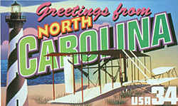 North Carolina Greeting: The design features the biplane built by Orville and Wilbur Wright that made the first manned flight by a heavier-than-air machine December 17, 1903, at Kill Devil Hill on North Carolina's Outer Banks. Dune grass native to the Outer Banks is shown beneath the plane's wings. At the left is the distinctive candy-striped lighthouse of Cape Hatteras.