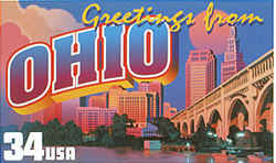 Ohio Greeting: depicts the skyline of Cleveland, including the well-known Terminal Tower, with the city's Veterans Memorial Bridge over the Cuyahoga River in the foreground. The sun hangs low in the sky behind the buildings, casting a pink glow on billowing cumulus clouds at the side. 