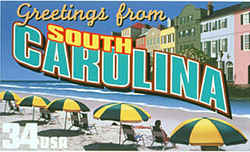 South Carolina Greeting: Beachgoers sit beneath a row of identical blue-and-yellow umbrellas on the sands of Myrtle Beach. At the rear is Rainbow Row, a row of multicolored buildings in Charleston.