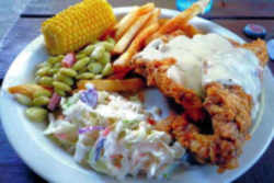 Fried okra, squash, cornbread, barbecue pork, biscuits, sausage and gravy, grits, corn, strawberries, chicken fried steak, pecan pie, and black-eyed peas.: Oklahoma State Meal