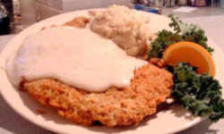 Fried okra, squash, cornbread, barbecue pork, biscuits, sausage and gravy, grits, corn, strawberries, chicken fried steak, pecan pie, and black-eyed peas.: Oklahoma State Meal